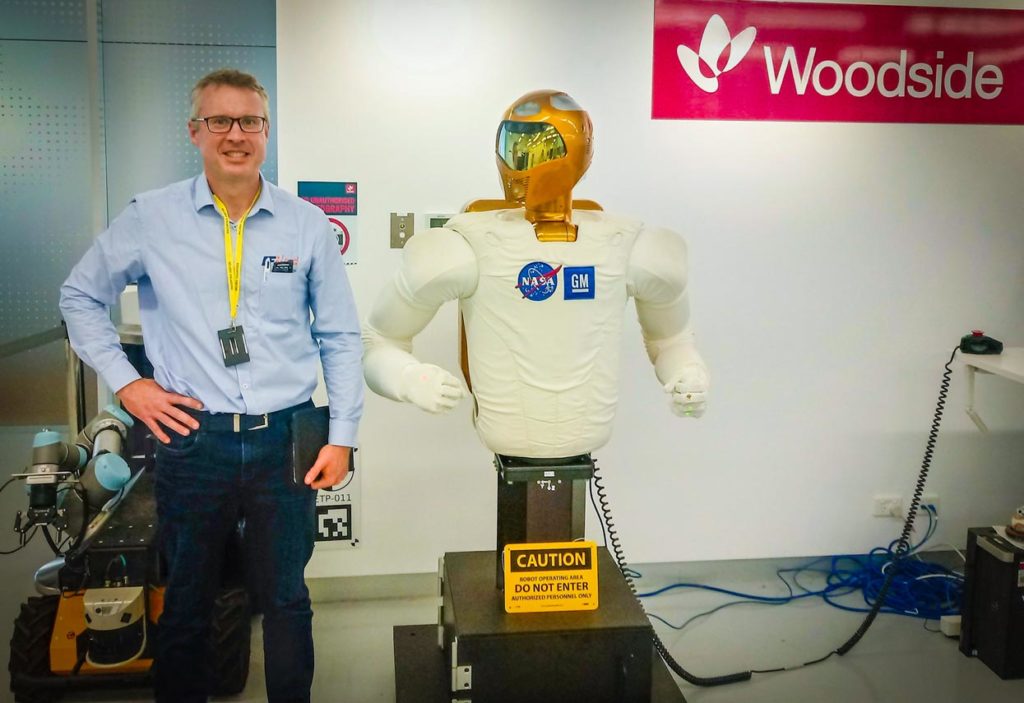 Mike Golden and a robot at Woodside's Robotics lab